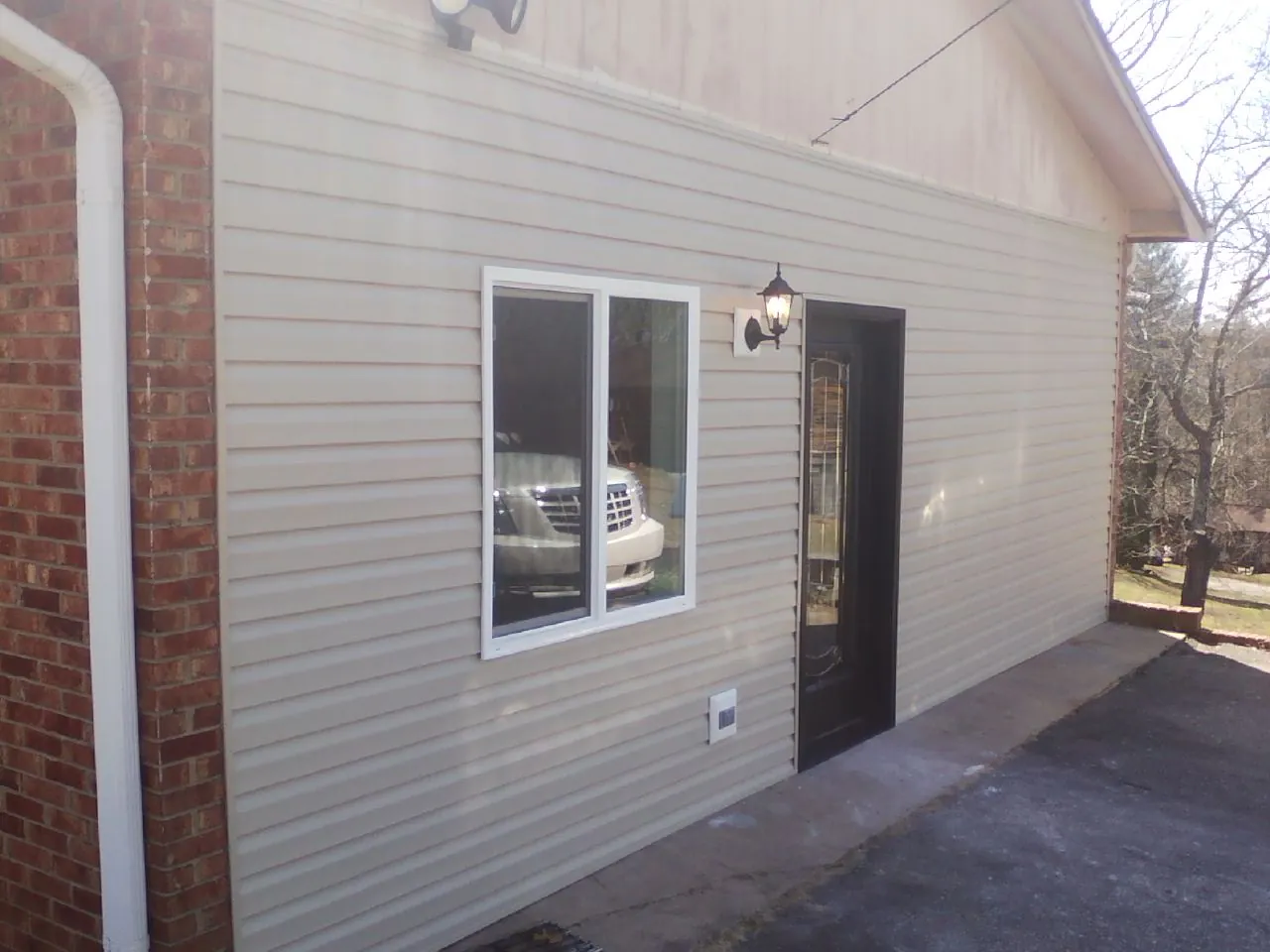 New vinyl siding and entry door on a room addition in Mount Vision
