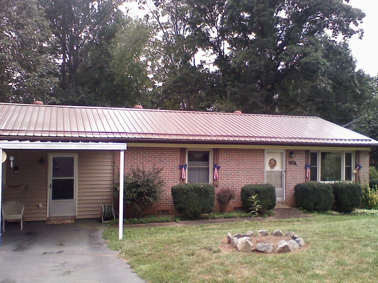 Bronze metal roof and carport on a brick ranch home — Roof Repair work by our crew in Mount Vision